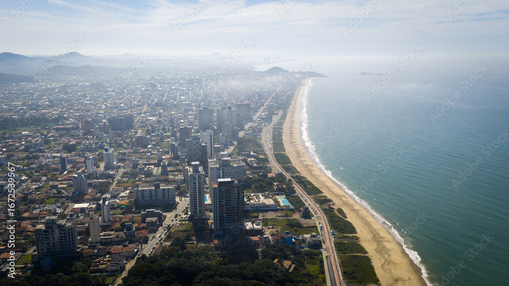 Fototapeta premium Aerial view of Balneário Piçarras coastline with full beachfront and cityscape.