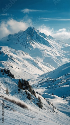 Snow-covered Mountains and Valleys Under a Clear Blue Sky in Winter