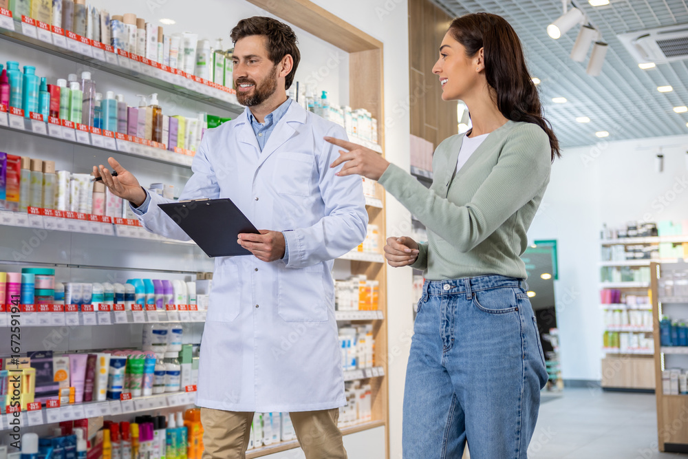 Obraz premium Male pharmacist talking to a woman and making notes