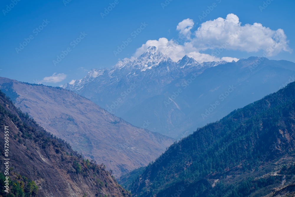 Fototapeta premium Himalayan mountain landscape in the alps with clouds and blue sky background