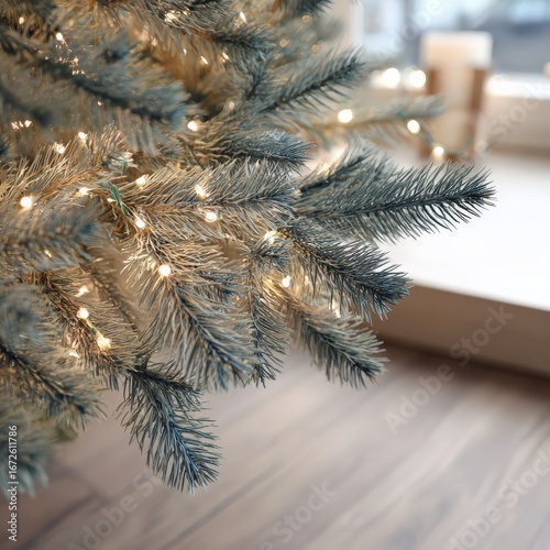 Close up view of christmas tree branches with warm lights in cozy indoor setting