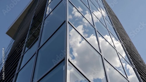 detailed perspective of modern architectural structure highlighting reflective glazed sections mirroring faint cumulus formations and azure firmament, accentuating balanced proportions and metropolit