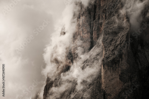 The northern side of Sasso Lungo among clouds from the Val Gardena area