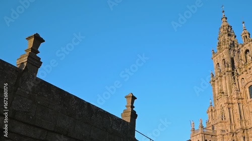 Pan motion showing a low angle of the santiago de compostela cathedral towers with blue sky