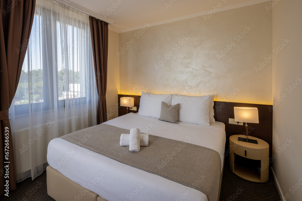 Fototapeta premium Interior of a hotel room with a large comfortable bed
