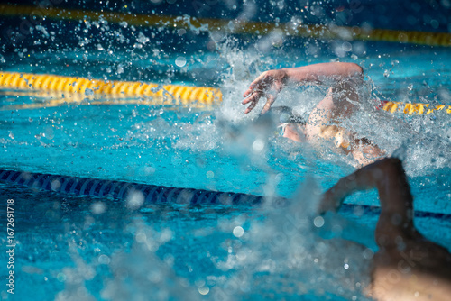 Race of freestyle swimmers boys in the pool