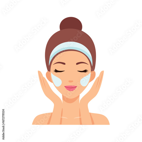 Woman with headband applying facial skincare product to her cheeks enjoying a relaxing beauty routine