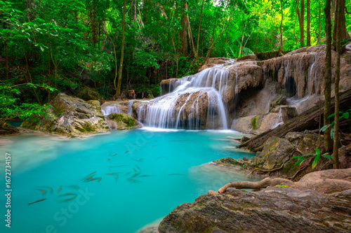 Arawan waterfall in tropical forest Thailand,leaf moving low speed shutter blur.Beauty in nature, amazing waterfall in tropical forest of national park, Thailand.