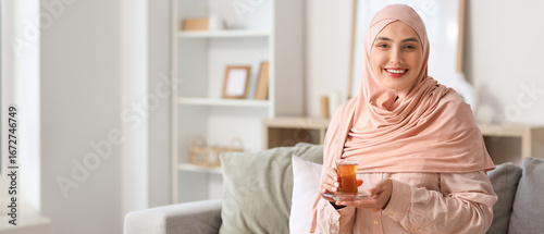 Young Muslim woman with gla...