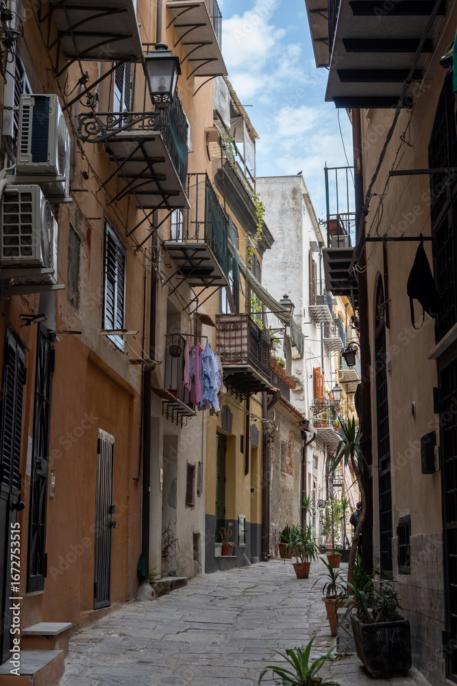 Naklejka premium View of streets of Palermo, citylife, ancient baroque churches, old narrow streets, Norman palaces, markets, Sicilian vacation destination, South of Italy