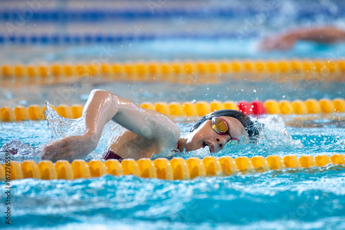 Swimmer swims freestyle swimming style in the pool