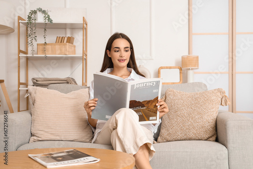 Young woman reading magazin...