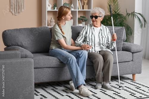 Young woman with blind gran...