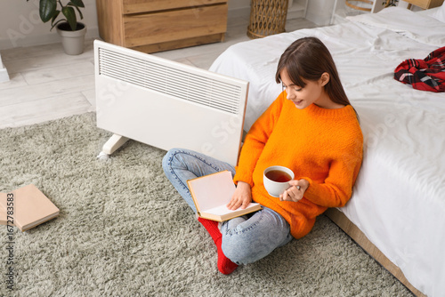 Young woman with tea readin...