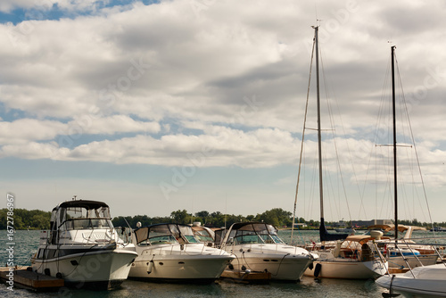 nice view of docked yachts floating on water at sunset time, summer gorgeous day, sailing travel background