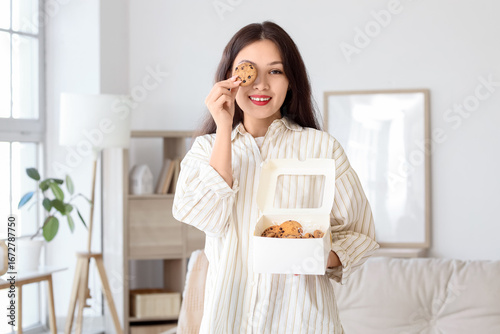Young Asian woman with box ...
