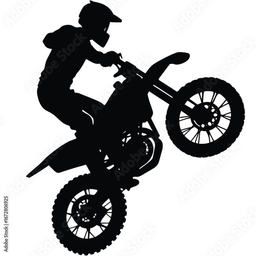 Motocross rider performing wheelie motorcycle stunt