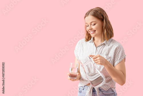 Young woman pouring water f...