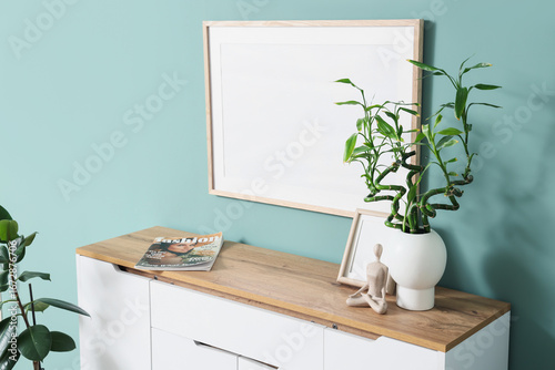 Vase with green twigs and p...