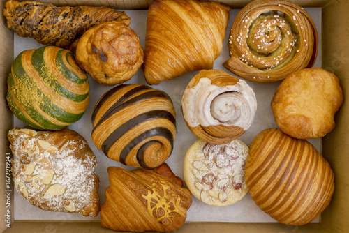  AI-Generated image of a box filled with assorted freshly baked pastries.