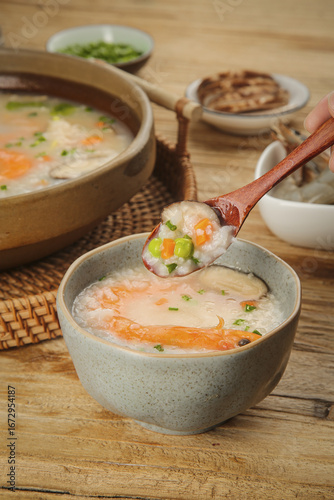 Delicious Shrimp and Vegetable Congee - Traditional Asian Seafood Rice Porridge in Ceramic Bowls