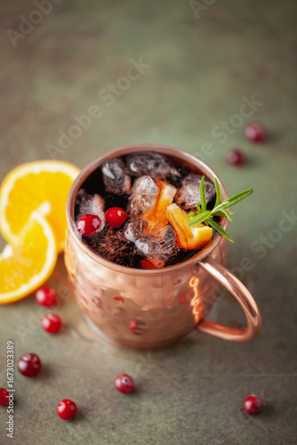 Photography Cranberry Orange Moscow mule, holiday drink in a copper mug.