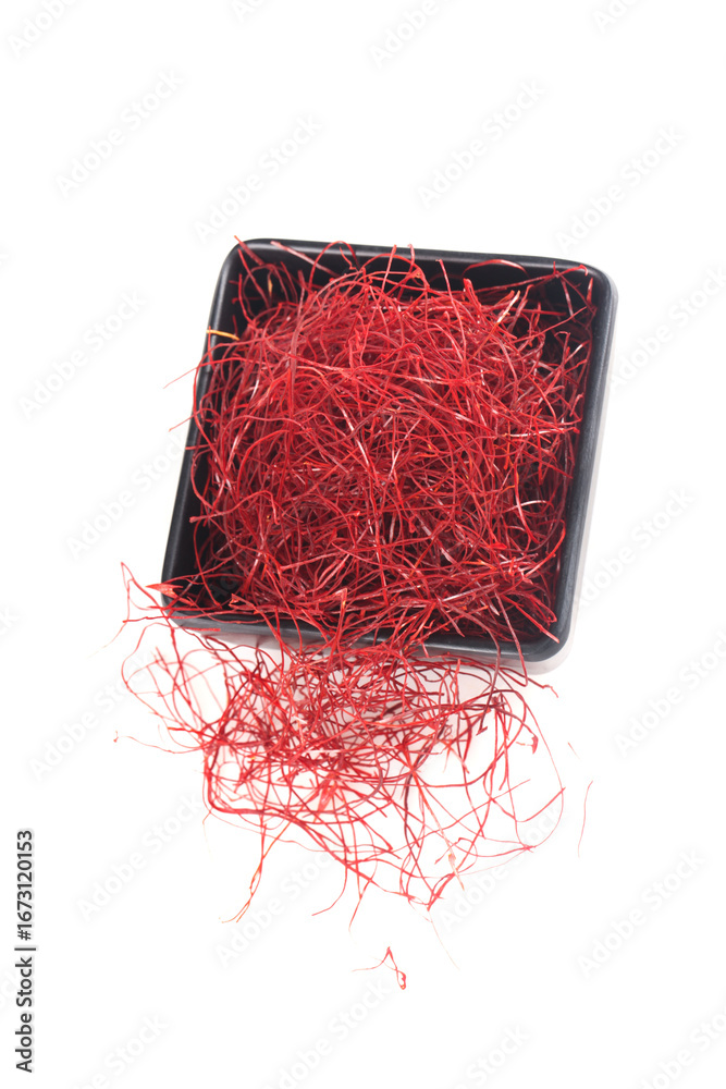 Fototapeta premium Dried Red Chili Pepper Shredded Fine Threads in Black Bowl on White Background