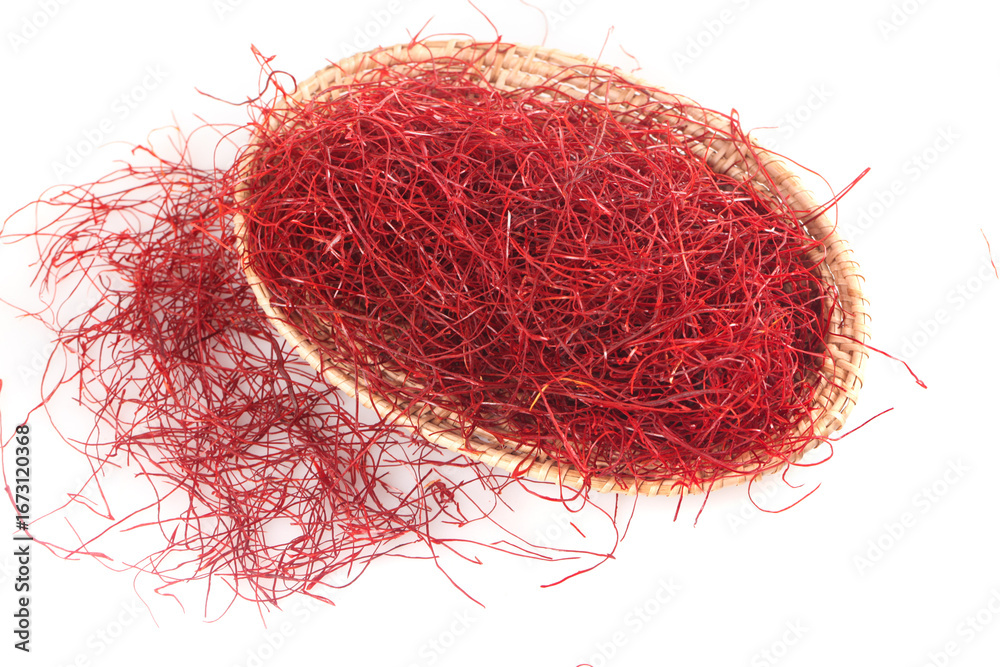 Naklejka premium Dried Red Saffron Threads in Wicker Basket on White Background