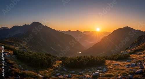 Fototapeta Naklejka Na Ścianę i Meble -  Golden Hour in the Tatra Mountains: Sunburst Over Valley and Peaks