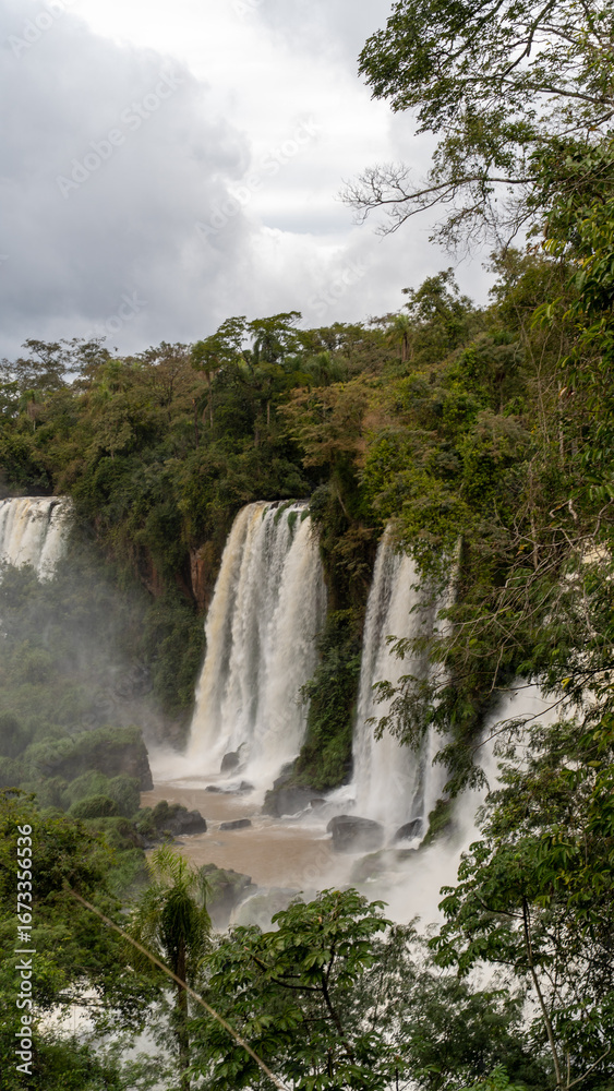 Fototapeta premium A Dynamic and Mystical Scene of Iguazu Falls Filled with Water Mist
