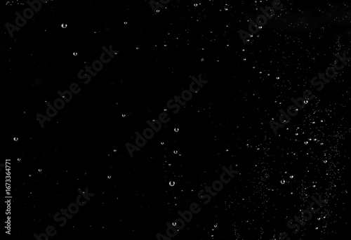 Wall Mural Water drops and splashes isolated on black background, perfect for design, freshness, nature, rain, moisture, abstract, and clean concepts