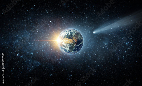 Fototapeta Naklejka Na Ścianę i Meble -  Comet, asteroid, meteorite flying to the planet Earth.  Glowing asteroid and tail of a falling comet threatening the safety of the Earth.  Elements of this image furnished by NASA.