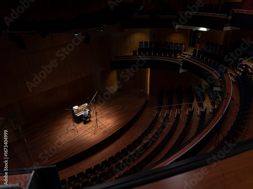 Photos Concert hall showing curved seating design and stage with piano setup