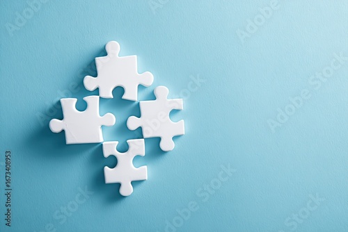 Four white puzzle pieces arranged on a light blue surface