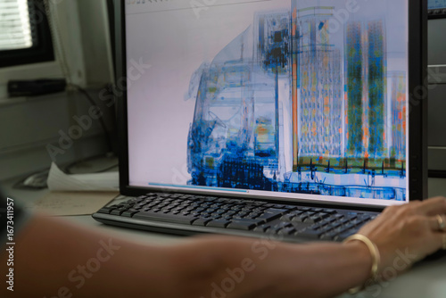 Computer display showing colorized X-ray scan analysis of cargo vehicle for customs inspection