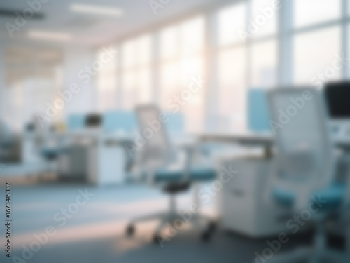 blurry image of office interior with bright, modern desk chairs and large windows	