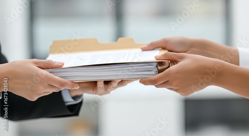 Close-up of two hands exchanging a file folder filled with documents, suggesting a business transaction or handover.