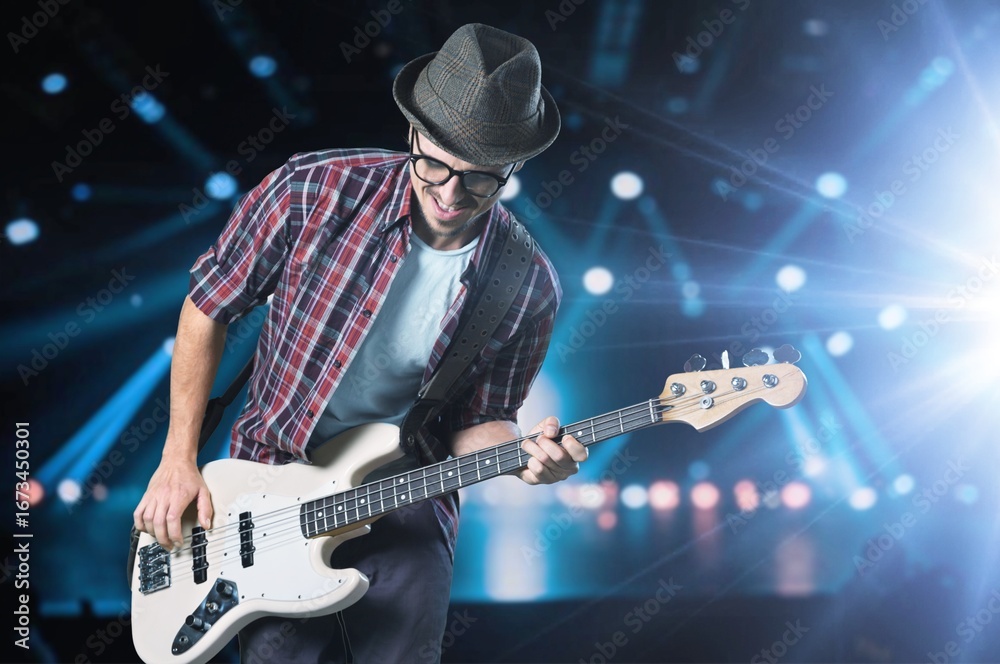 Obraz premium Bassist's music man hands playing on guitar