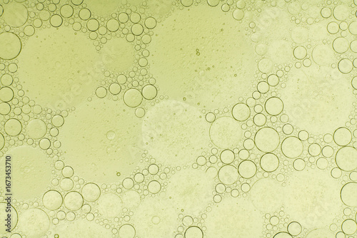 Macro microscope green bubble texture, Close-up Green bubbles and drops oil background . blue green water bubbles, close up golden oil drop for cosmetic