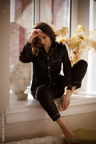 brunette girl in black silk pajamas