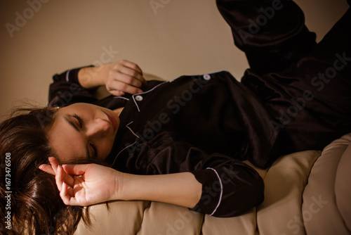 brunette girl in black silk pajamas