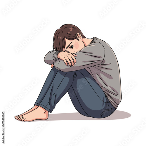 Young man sitting with head down, expressing feelings of sadness and introspection in a thoughtful pose 