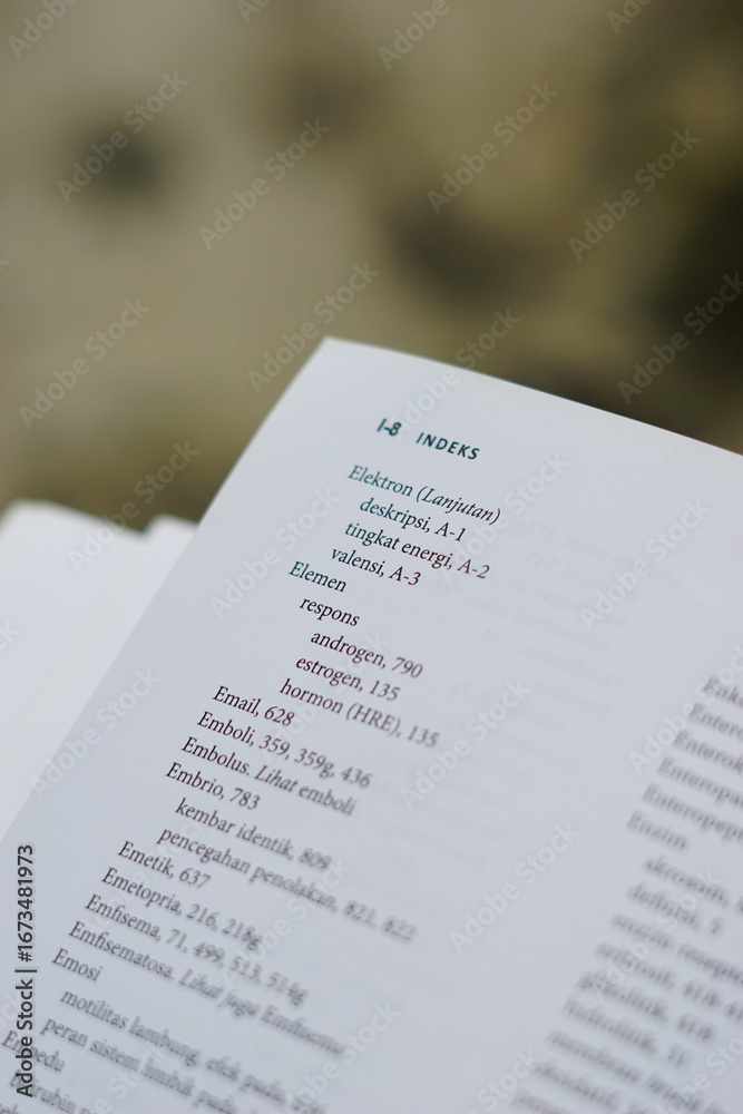 Obraz premium A close-up of an open medical textbook, showing detailed text and diagrams about human physiology and biology. This image represents study, education, research, and the journey of a medical student.