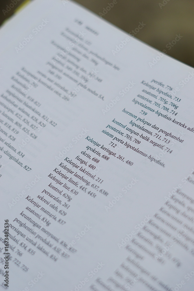 Obraz premium A close-up of an open medical textbook, showing detailed text and diagrams about human physiology and biology. This image represents study, education, research, and the journey of a medical student.