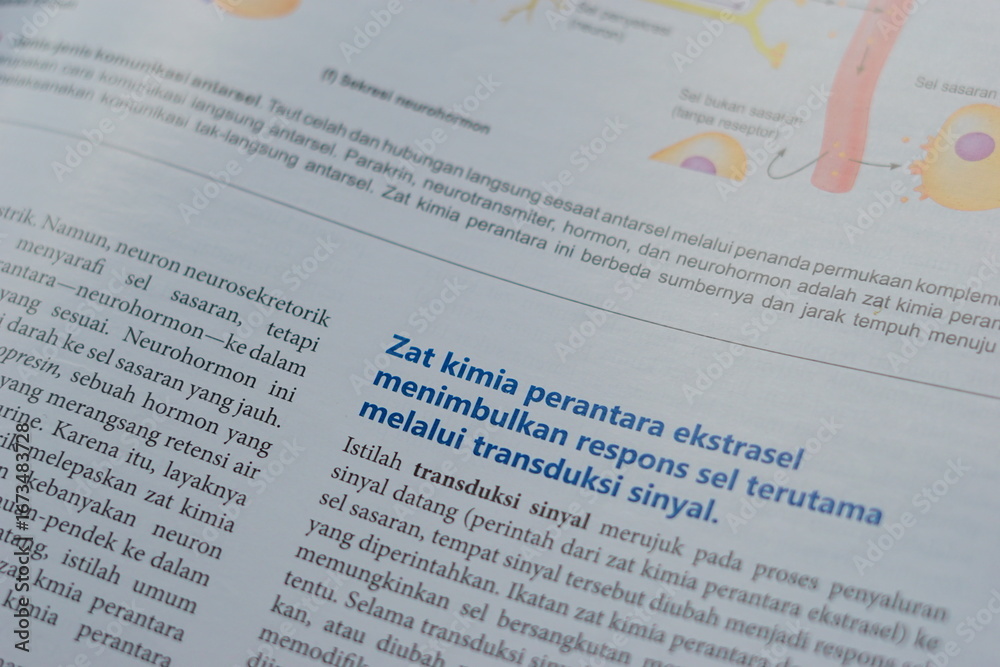 Obraz premium A close-up of an open medical textbook, showing detailed text and diagrams about human physiology and biology. This image represents study, education, research, and the journey of a medical student.
