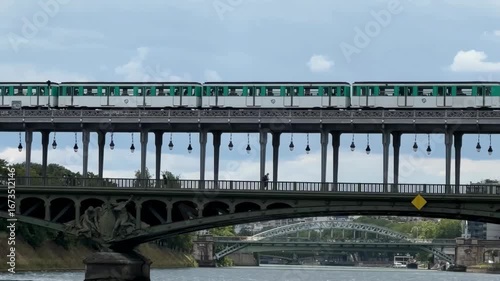 Dynamic 4K traveling video of Paris metro crossing Seine River bridge.