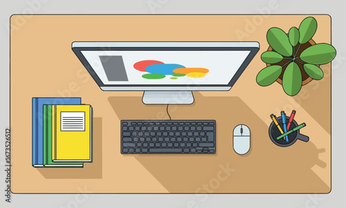 Overhead view of a clean desk with computer and books.