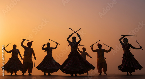 Silhouette of Dancers Performing Dandiya Raas at Sunset