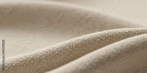 Soft, textured fabric with gentle folds and a warm, neutral beige color, highlighting the subtle surface details and natural drape