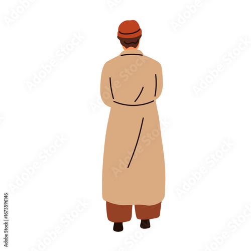 Man standing, view from back, behind. Young male in long coat and beanie hat,...